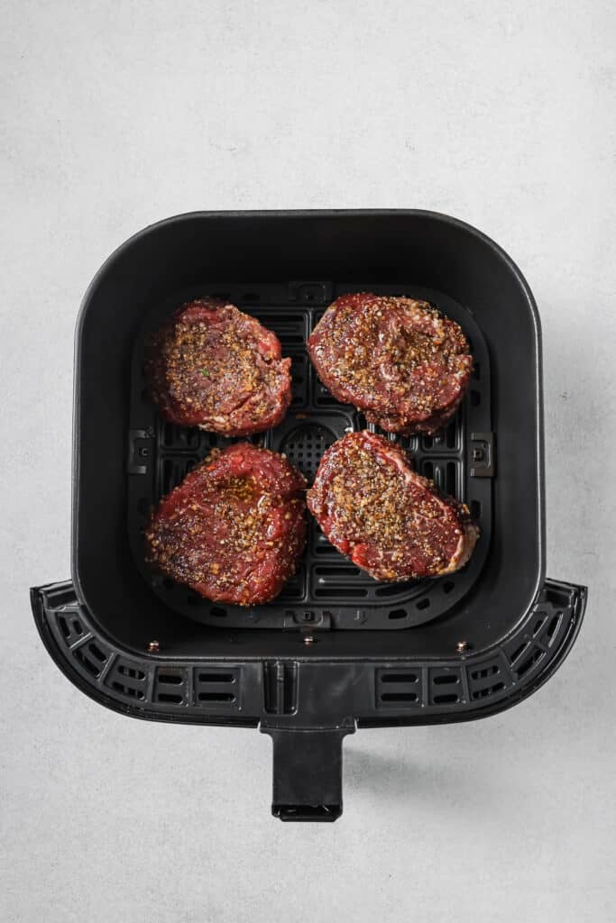 Filets in a single layer in the air fryer basket.