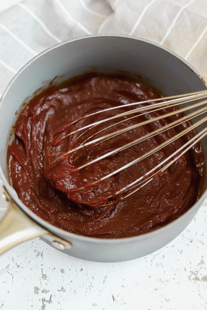 whisking whole30 bbq sauce in a sauce pan