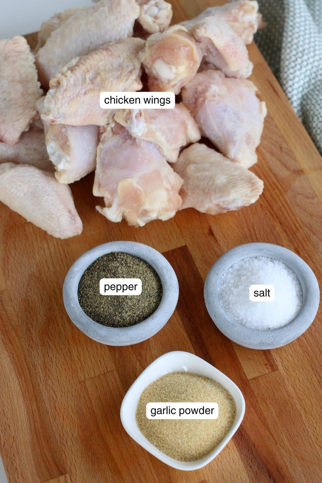 Chicken wings, salt, pepper, and garlic powder portioned out.