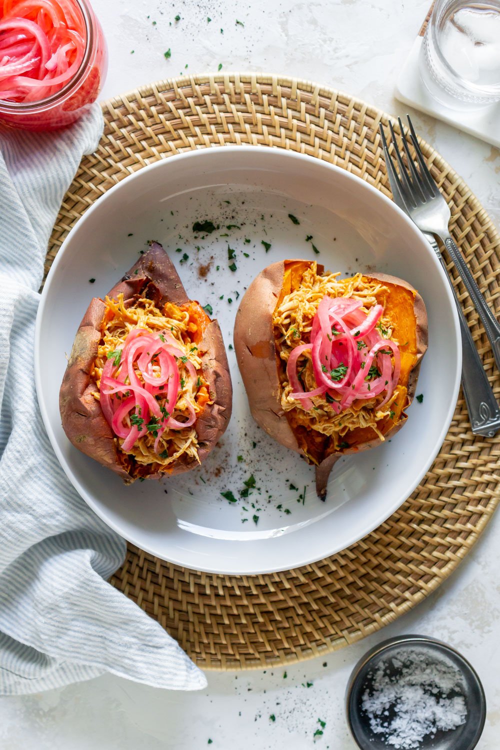 Sweet potatoes with bbq chicken on a plate with a fork.