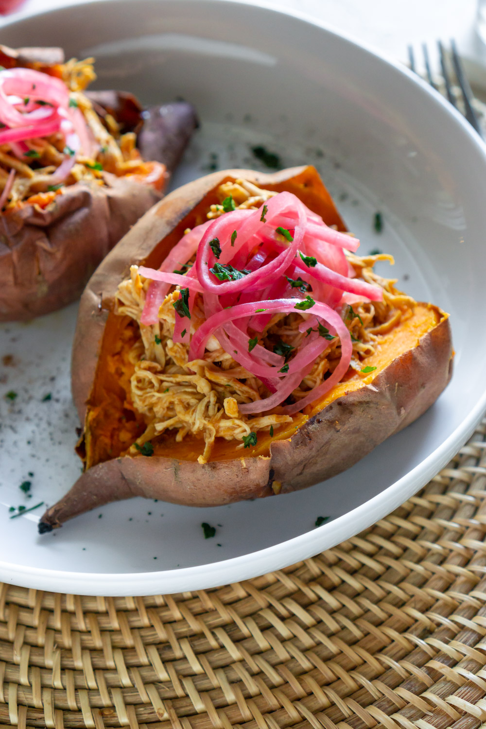 Stuffed sweet potato in a white bowl.