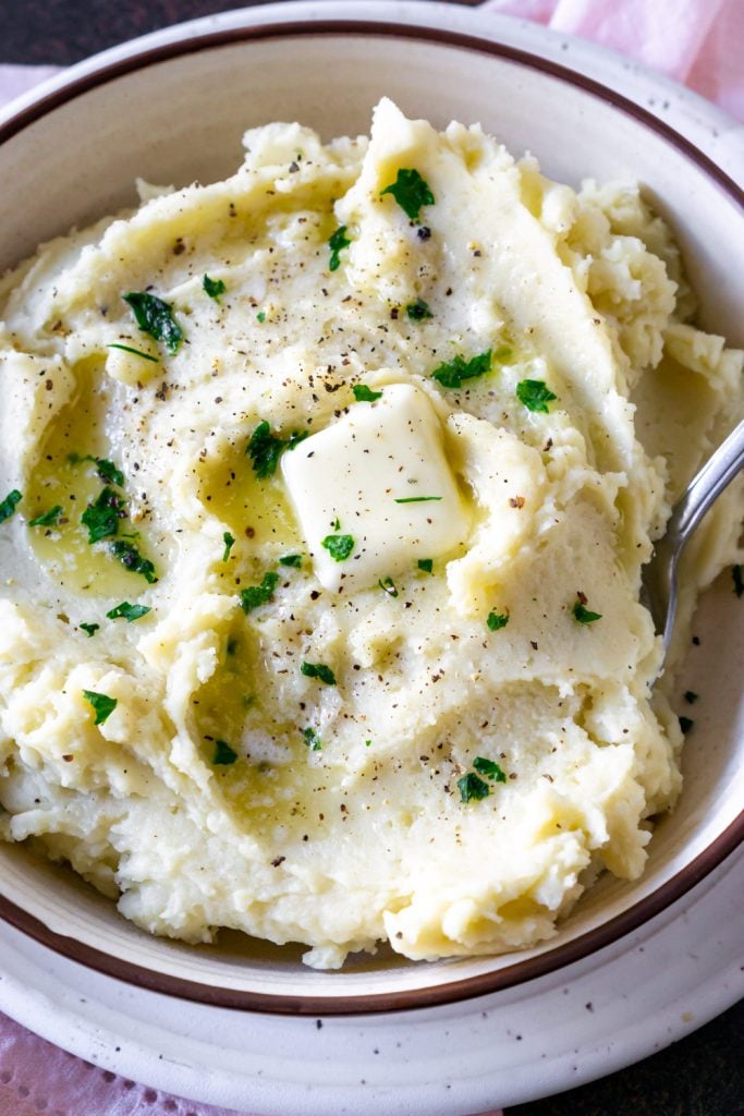 roasted garlic mashed potatoes in a bowl with a spoon