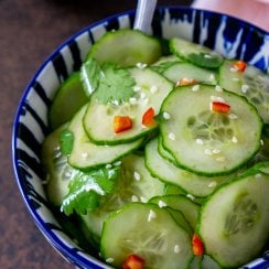 asian cucumber salad in a blue bowl