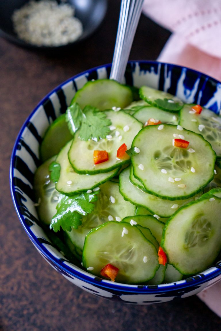 asian cucumber salad in a blue bowl