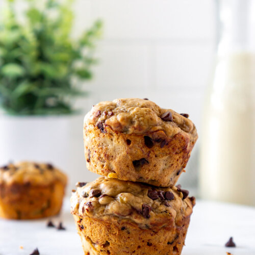 two banana bread muffins stacked on a marble tray