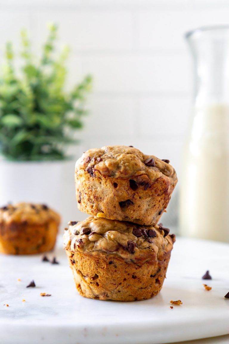 two banana bread muffins stacked on a marble tray