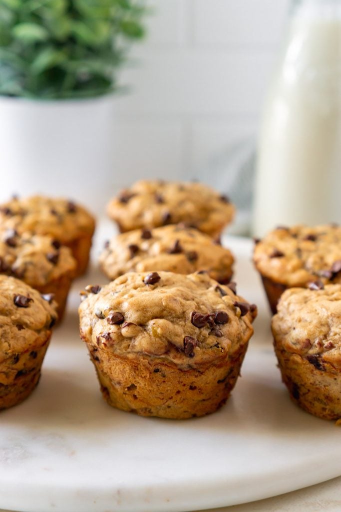 banana bread muffins on a marble tray with milk