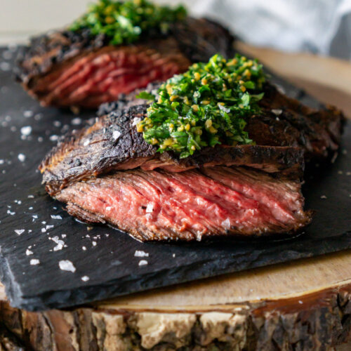 chimichurri steak on a black slate board