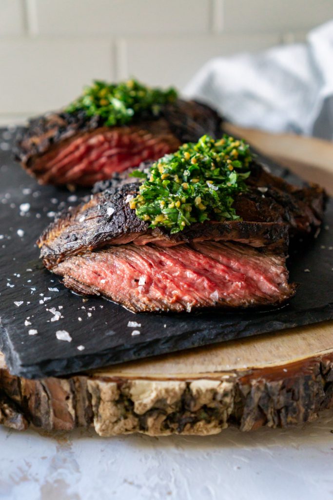 chimichurri steak on a black slate board