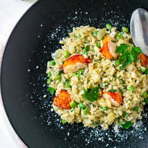 lobster risotto on a black plate