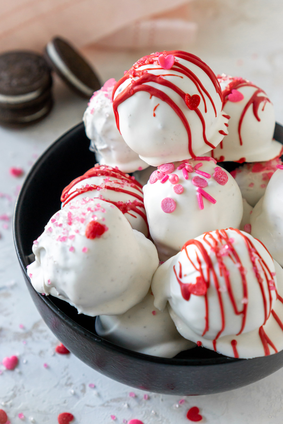 Chocolate cake balls stripped with pink candy melts for Valentines
