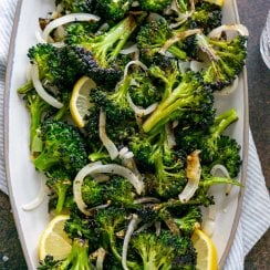 roasted broccolini on a grey serving tray