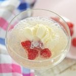 valentine's day champagne float in a glass cup with raspberries