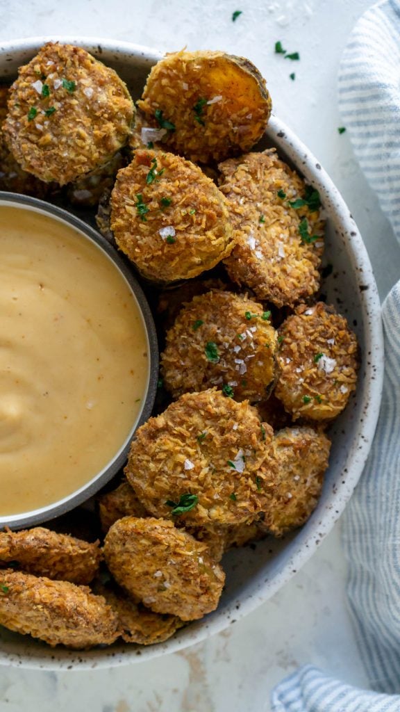 air fryer pickles in a bowl with spicy mayo