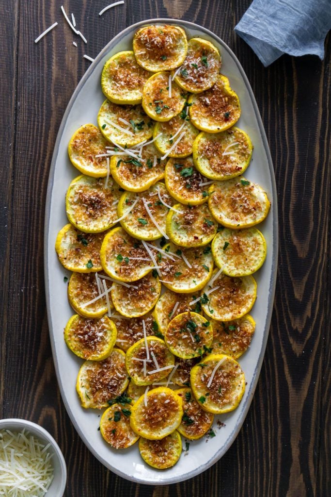 roasted yellow squash on a plate with a blue napkin