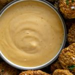 spicy mayo in a small bowl with fried pickles