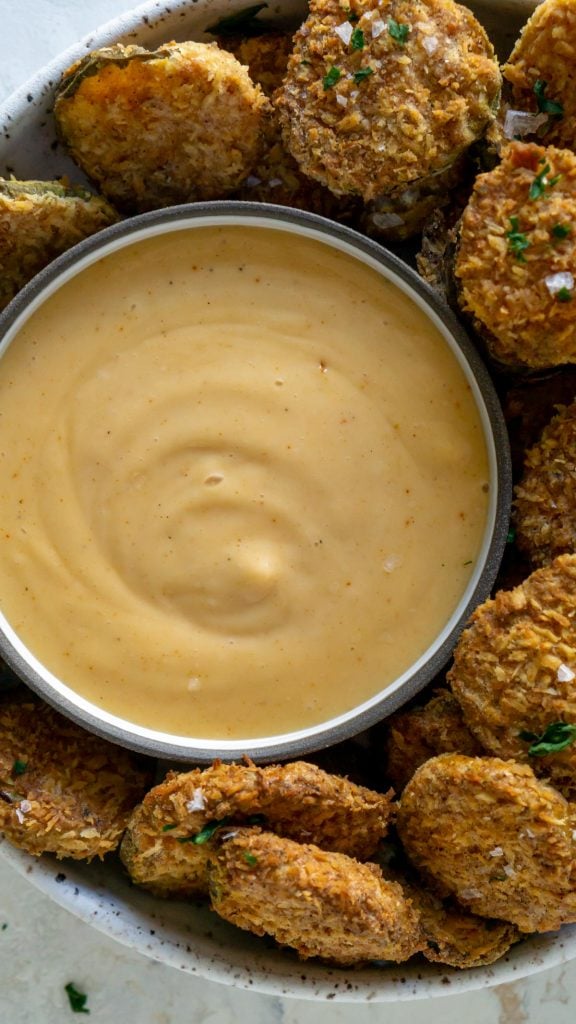spicy mayo in a small bowl with fried pickles