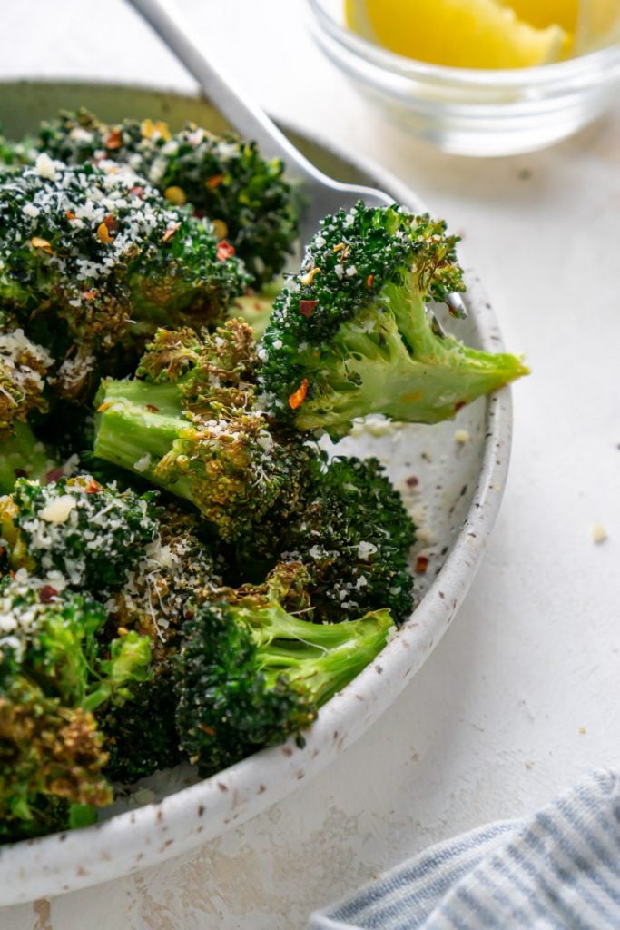 air fryer broccoli in a bowl with a silver fork