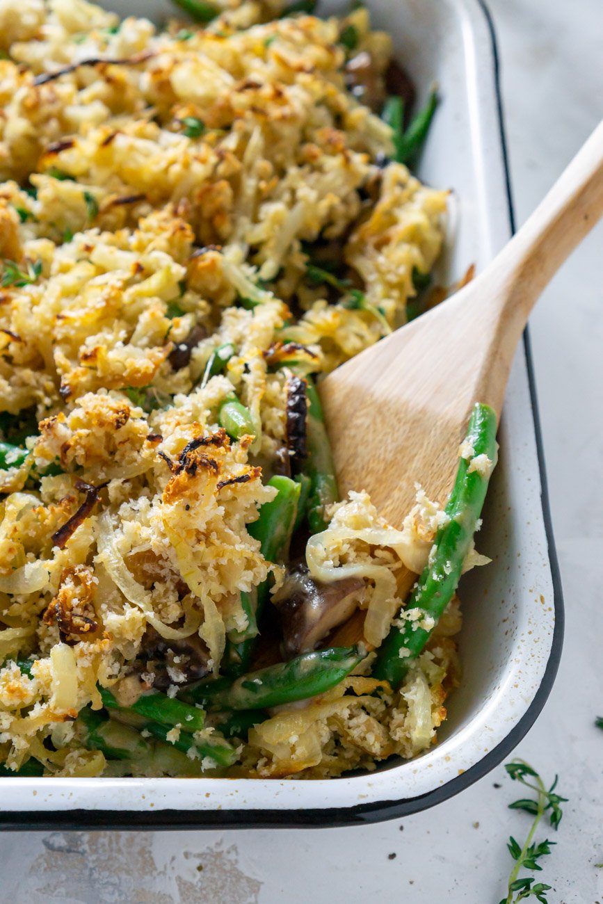 wooden spoon serving healthy green bean casserole