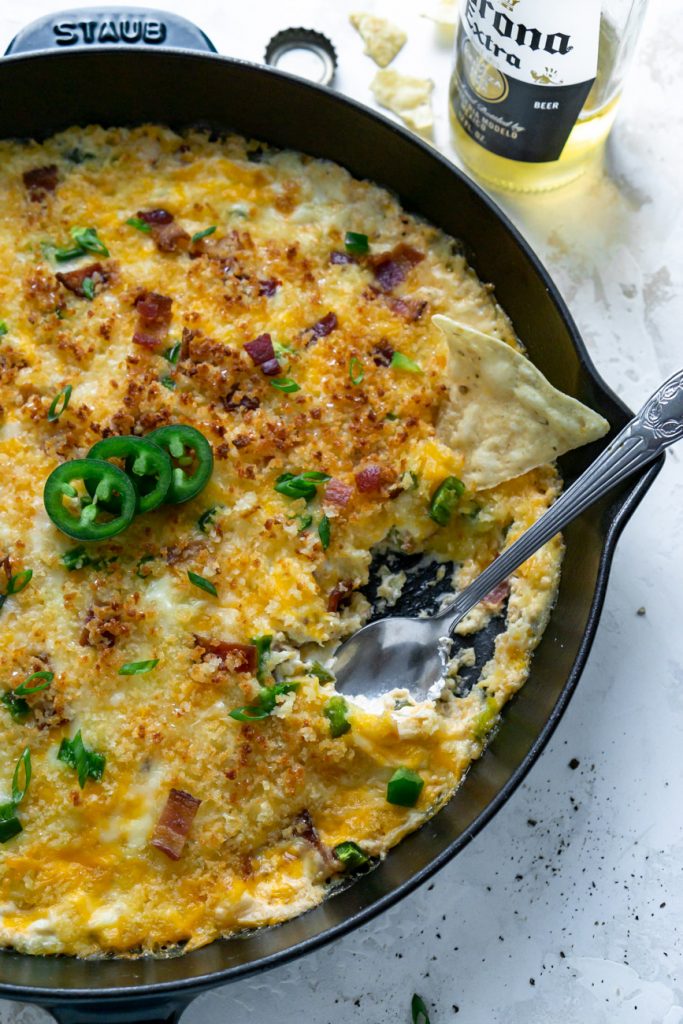jalapeno popper dip in a skillet with a silver spoon