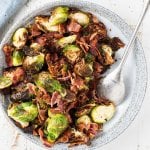 brussels sprouts and bacon on a white dish