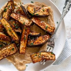 air fryer eggplant fries on a plate with a silver fork
