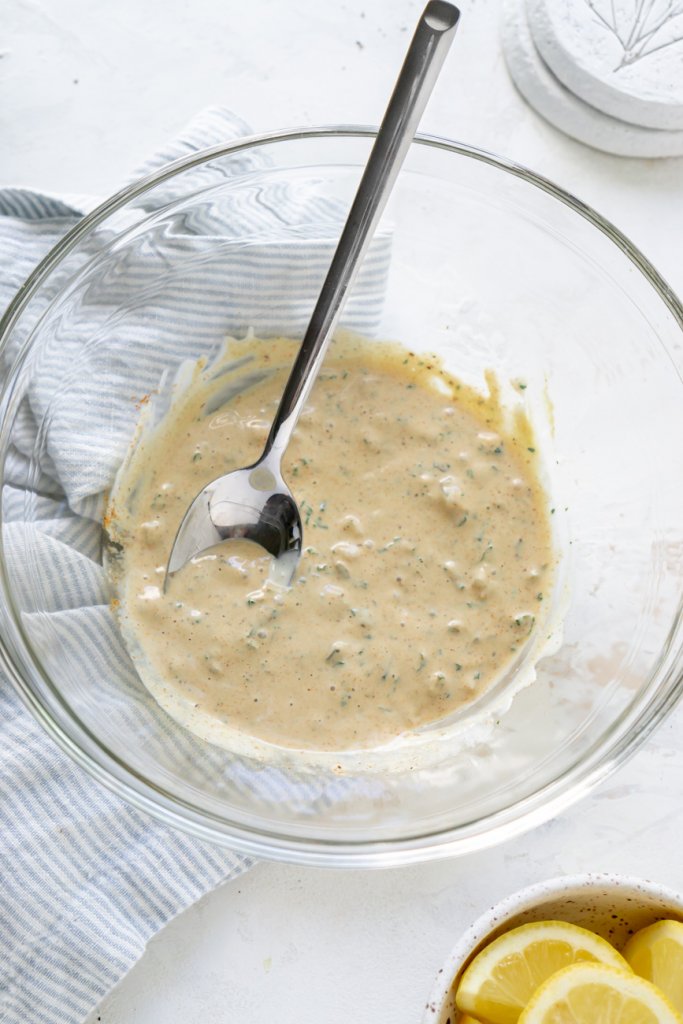 mixing crab cake sauce ingredients in a mixing bowl