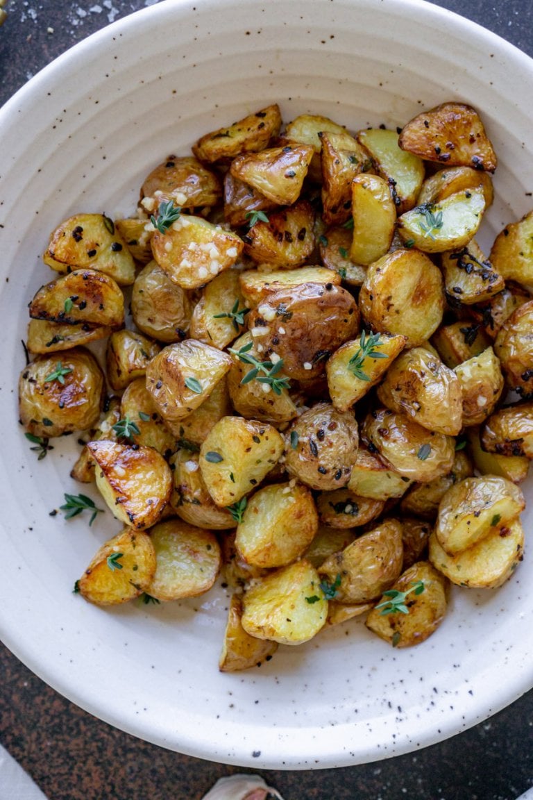 roasted garlic potatoes in a white bowl.