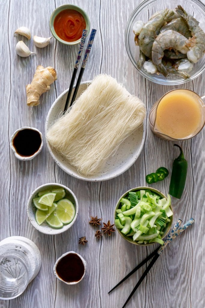 pho ingredients: rice noodles, bok choy, ginger, broth, shrimp, soy sauce, limes