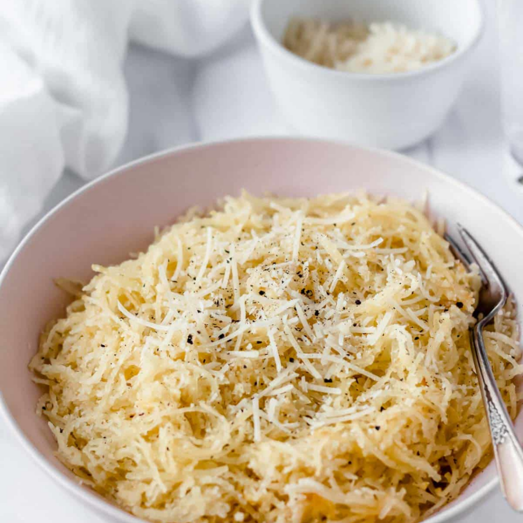spaghetti squash cacio e pepe in a white bowl with a fork