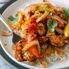 air fryer shrimp and peppers on a white plate with rice