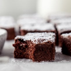 close up of a dark chocolate brownie with a bite taken