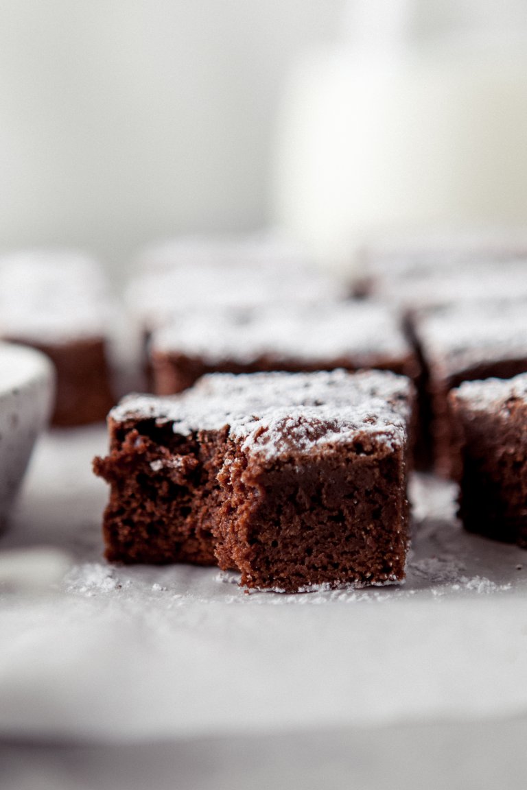 close up of a dark chocolate brownie with a bite taken