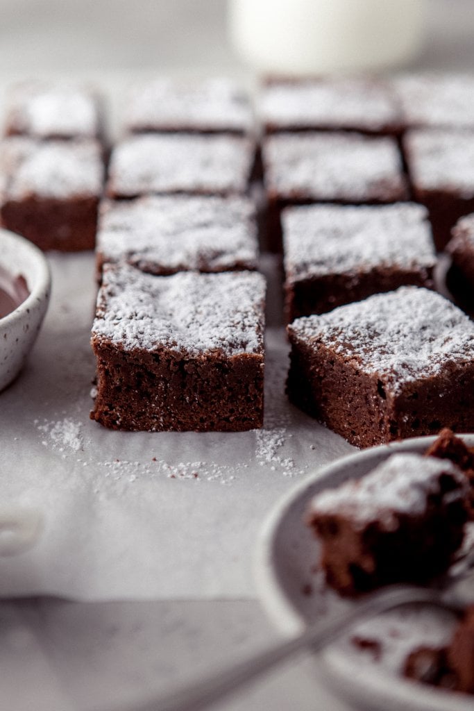 dark chocolate brownies on parchment paper