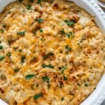 Maryland crab dip in a white baking dish garnished with fresh parsley.