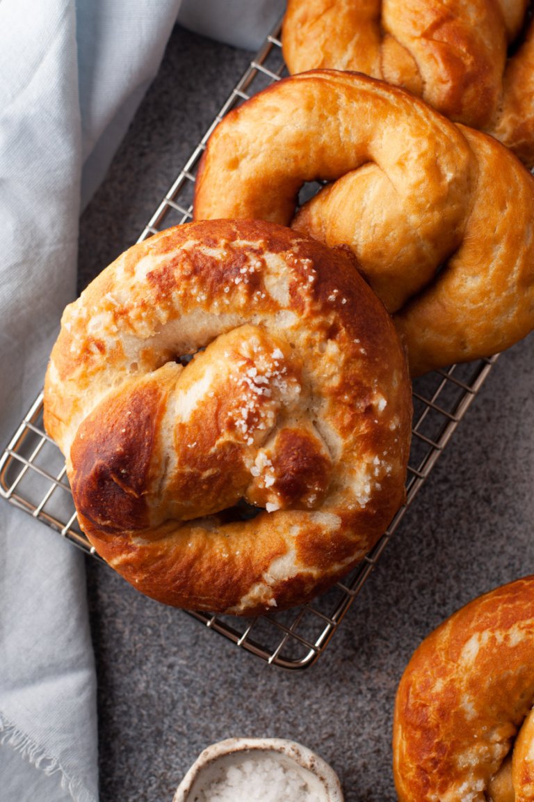 3 homemade soft pretzels on a cooling rack