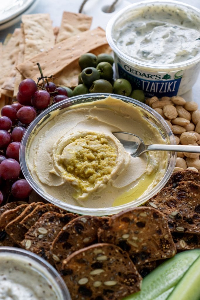 lemon hummus on a mezze platter with grapes and crackers