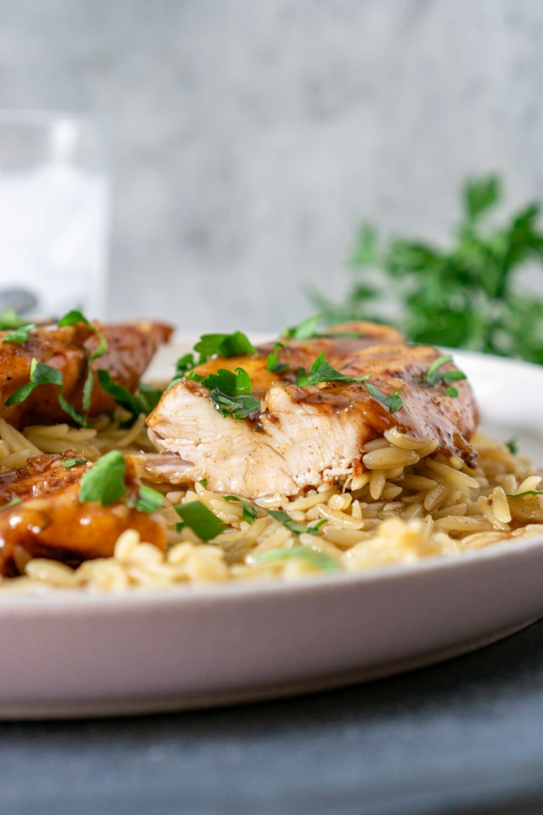 chicken sliced on a plate with orzo