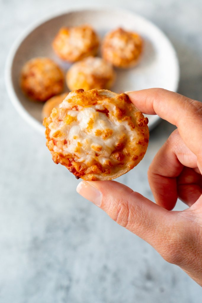 hand holding a bagel bite