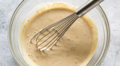 remoulade sauce in a glass mixing bowl with a whisk