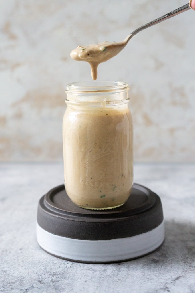a jar of remoulade sauce with a spoon