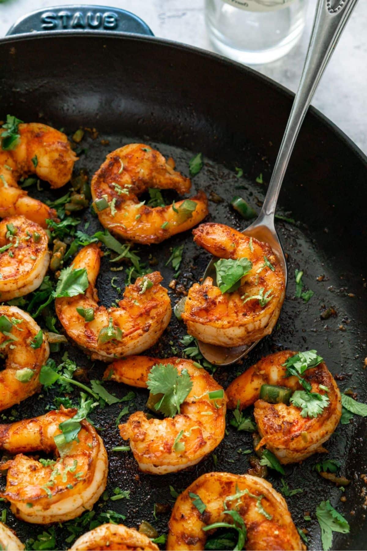 Tequila Lime Shrimp in a cast iron pan garnished with cilantro.