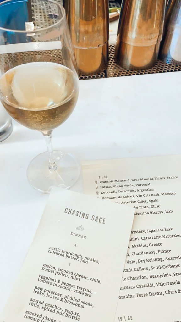 wine glass and menu at chasing sage