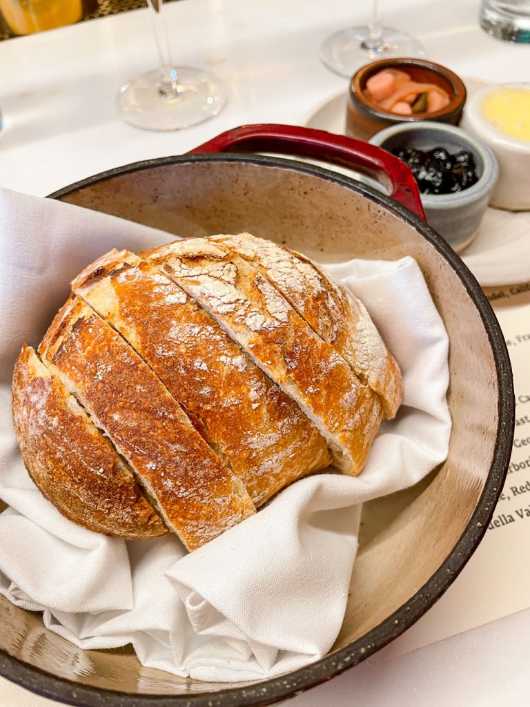 A loaf of sourdough bread in a dutch oven