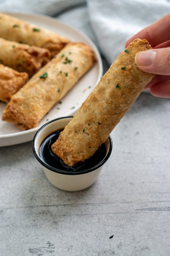 dipping egg roll in soy sauce