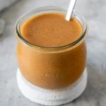 coconut curry sauce in a glass jar with a spoon