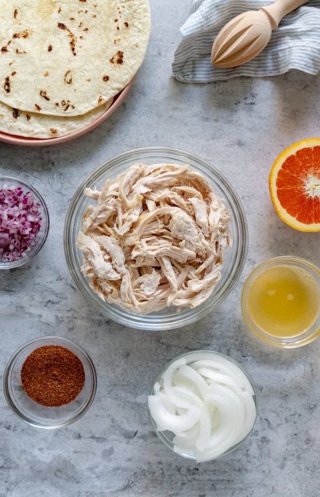 ingredients in bowls: turkey, spices, onions, orange, red onion, tortillas