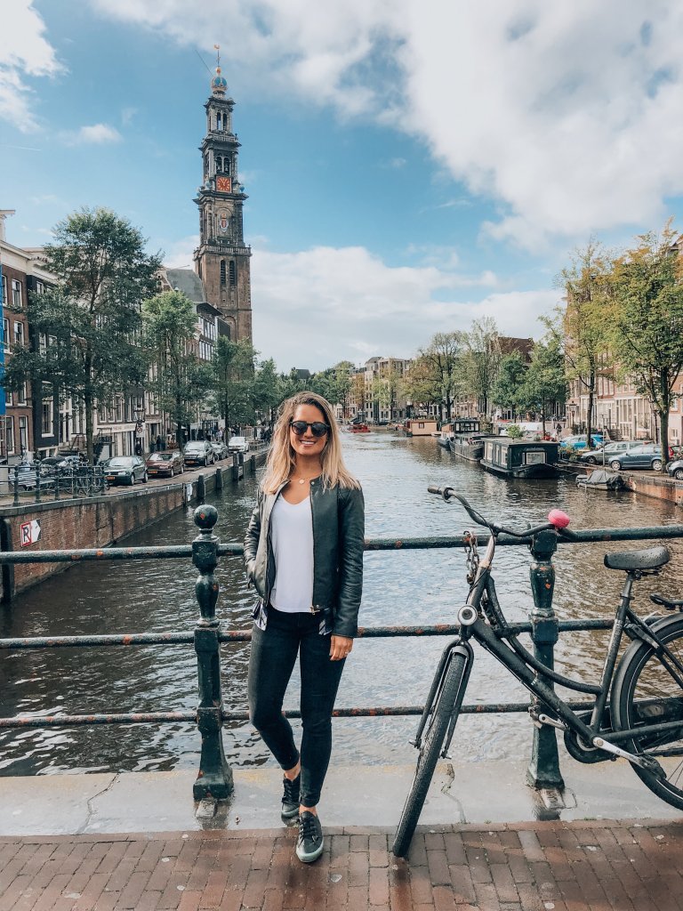 girl standing on a bridge over water