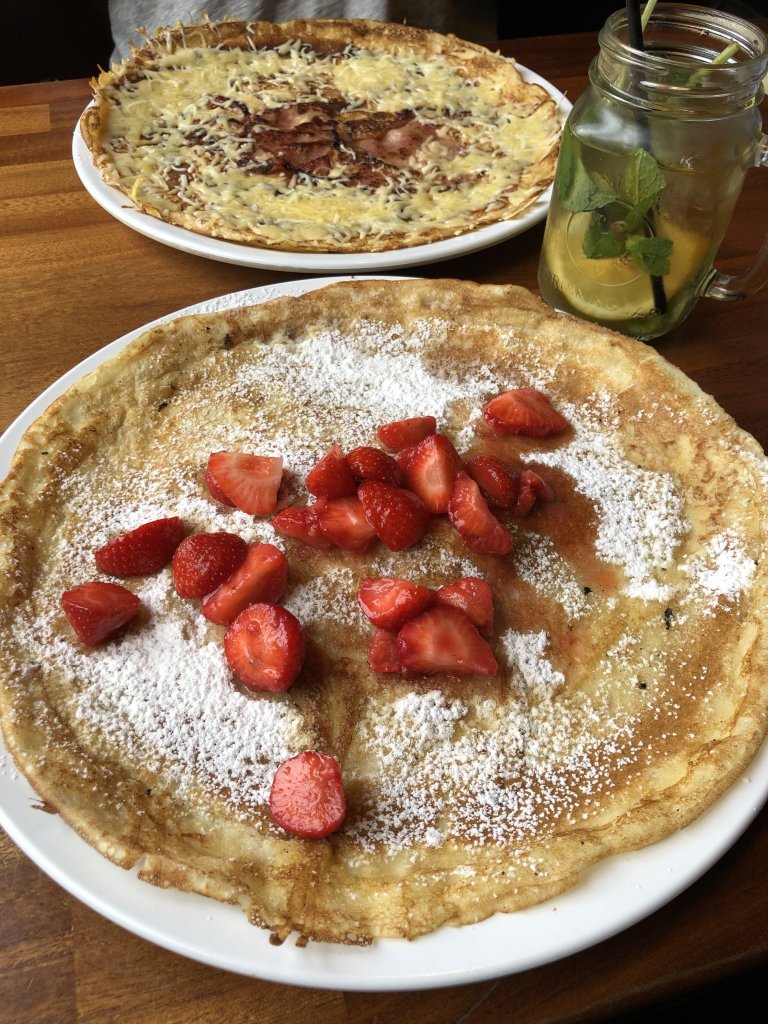 2 large dutch pancakes, one with strawberries on top