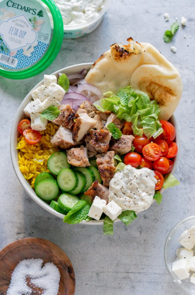 chicken shawarma bowl with naan bread and feta dip on the side